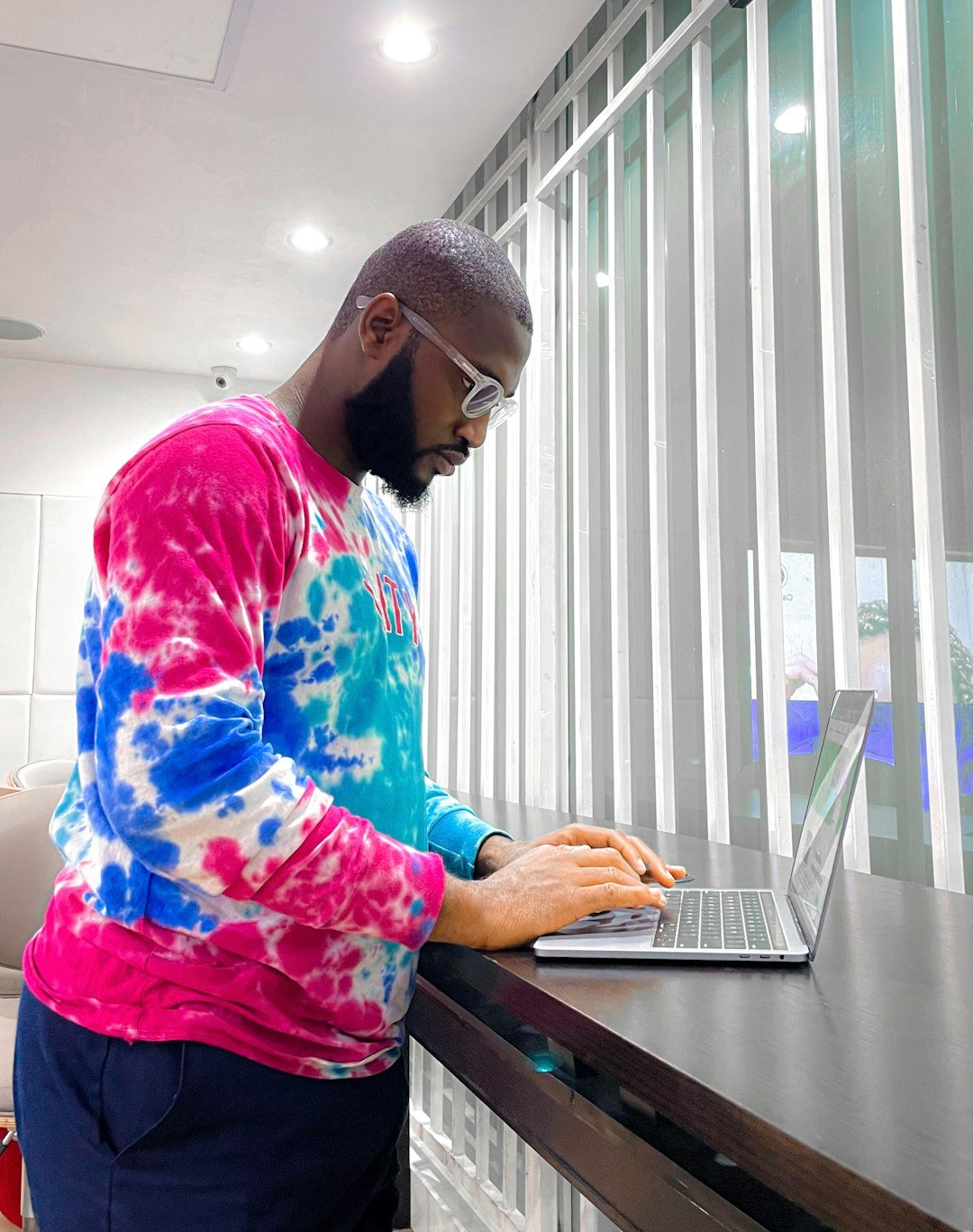 Photo by Francis Odeyemi a man using a laptop